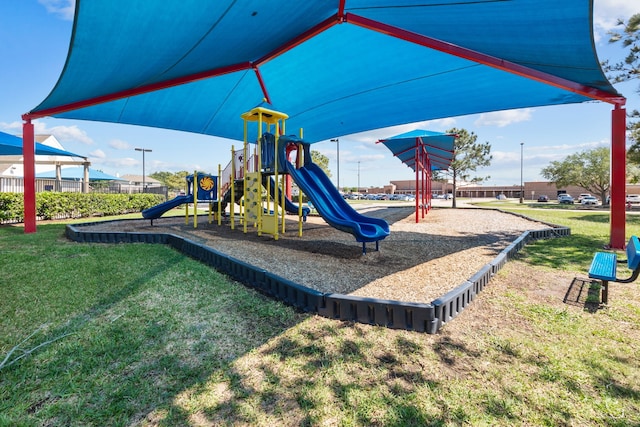 view of playground with a lawn