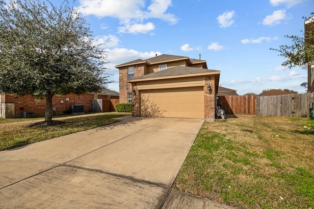 view of front of house featuring cooling unit, a garage, and a front yard