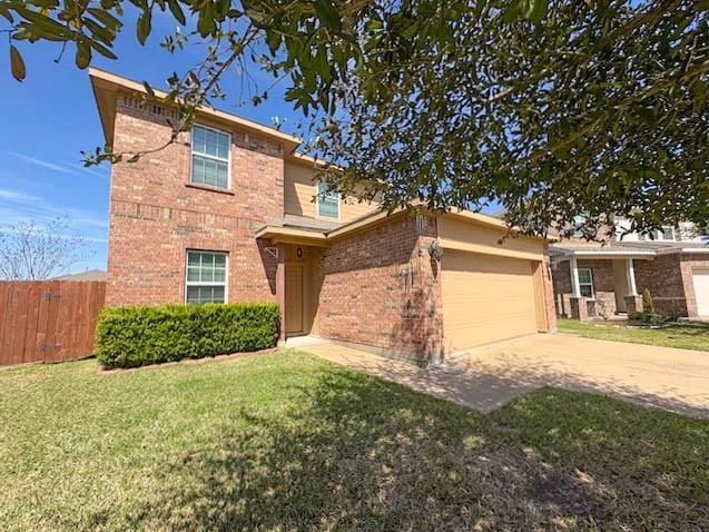 view of front of property with concrete driveway, brick siding, a front yard, and fence