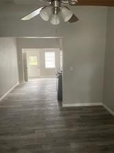 interior space with ceiling fan and dark hardwood / wood-style floors