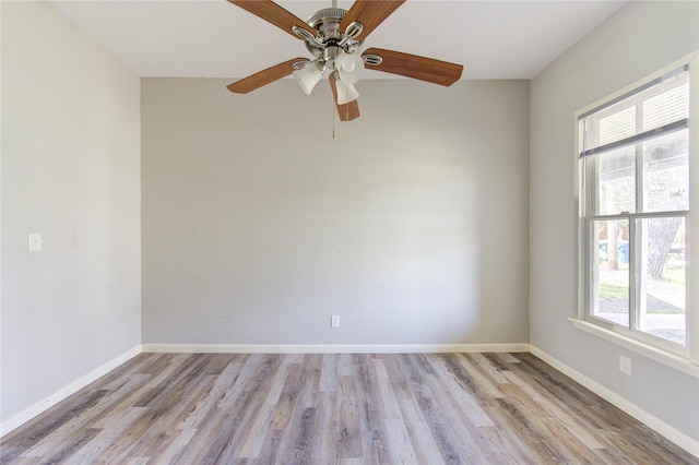 unfurnished room with baseboards, light wood finished floors, and a healthy amount of sunlight