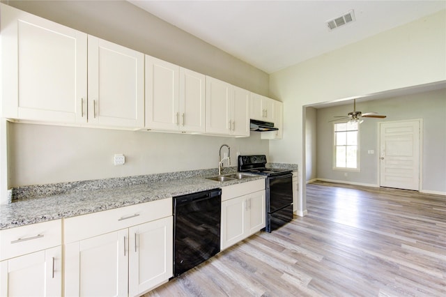 kitchen featuring a sink, visible vents, white cabinetry, light wood-type flooring, and black appliances