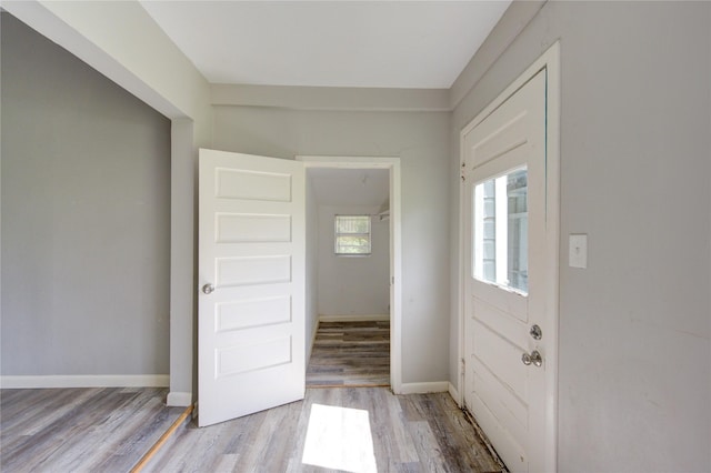 entrance foyer with light wood-style flooring and baseboards