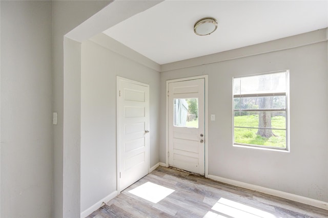 entryway with light wood-type flooring and baseboards