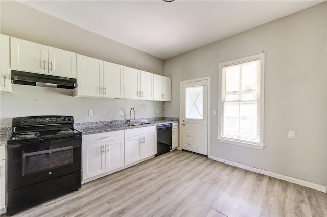 kitchen with under cabinet range hood, a sink, white cabinetry, black appliances, and light wood finished floors