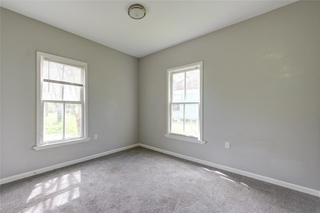 empty room with baseboards, carpet flooring, and a healthy amount of sunlight