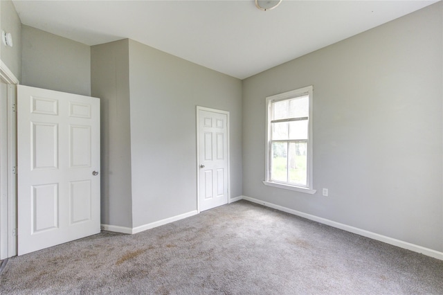 unfurnished bedroom featuring baseboards and carpet flooring