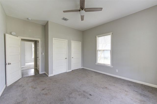 unfurnished bedroom with ceiling fan, carpet floors, visible vents, baseboards, and a closet