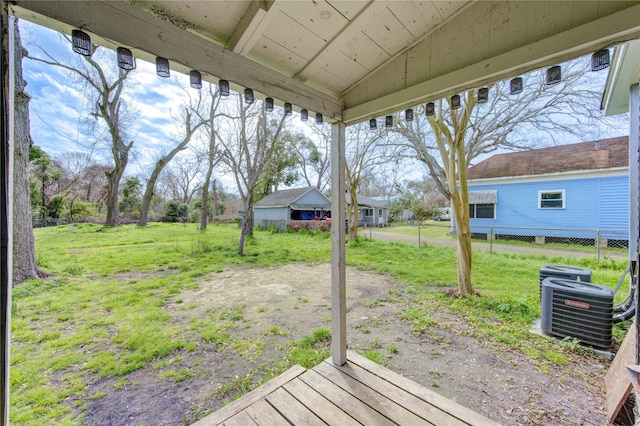 view of yard with fence and central air condition unit