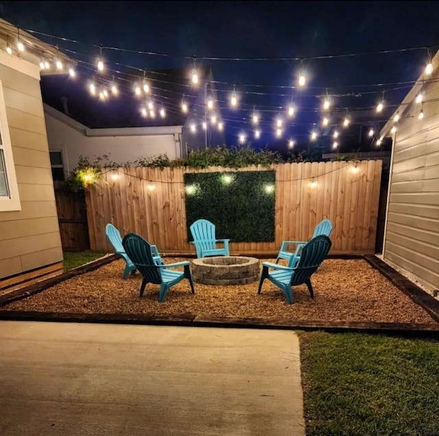 patio at twilight featuring an outdoor fire pit