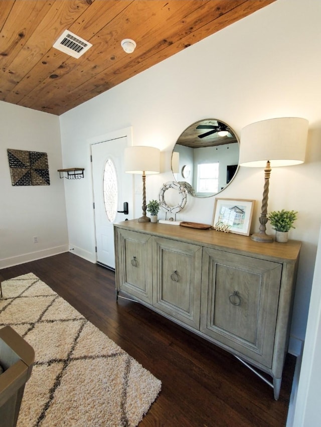 entryway with vaulted ceiling, wooden ceiling, and dark hardwood / wood-style floors