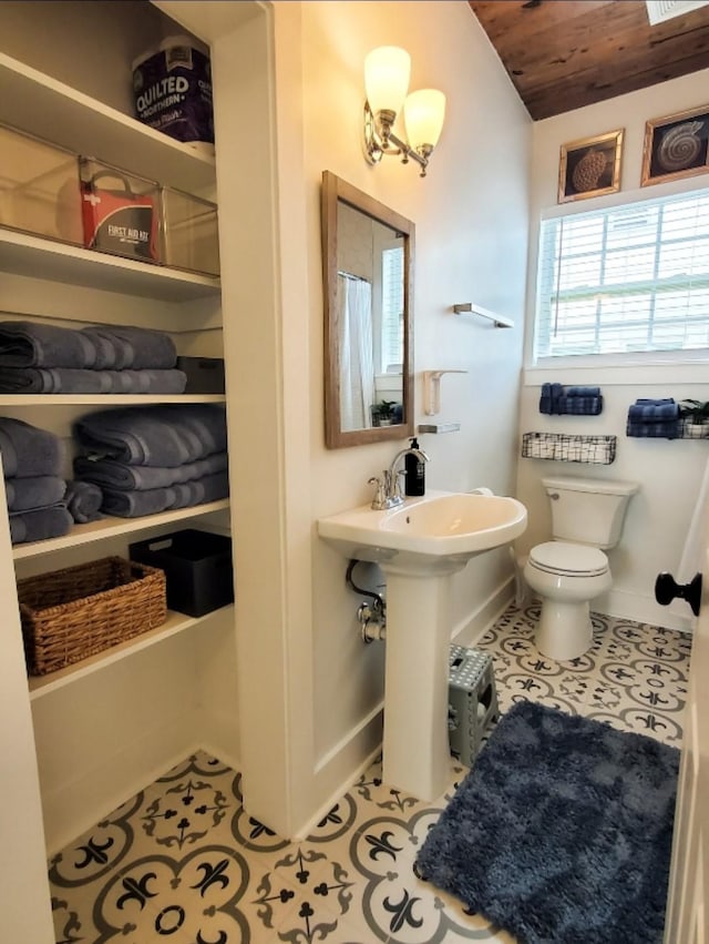 bathroom featuring lofted ceiling, sink, tile patterned flooring, wooden ceiling, and toilet