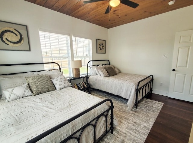 bedroom with ceiling fan, dark hardwood / wood-style floors, and wooden ceiling