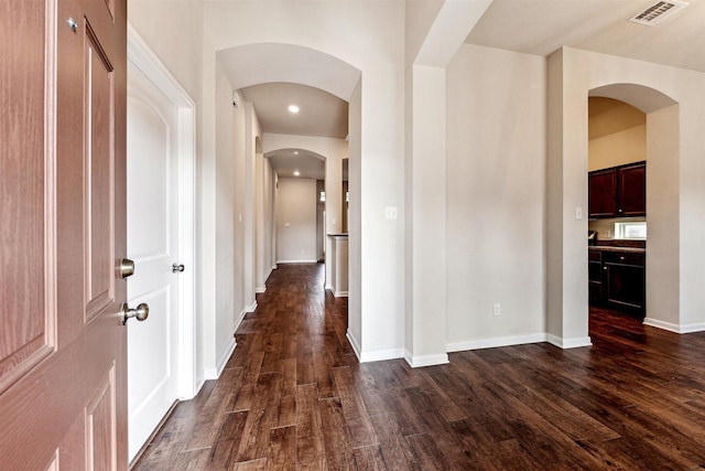 corridor featuring dark hardwood / wood-style flooring