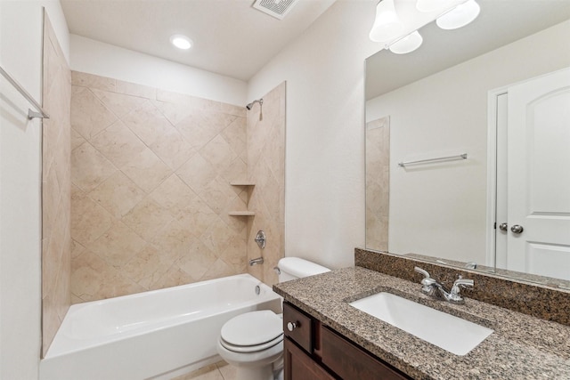 full bathroom with tiled shower / bath, vanity, and toilet