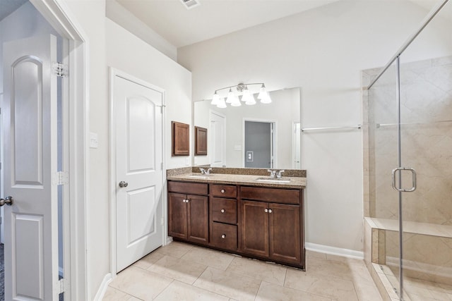 bathroom with tile patterned floors, vanity, and an enclosed shower