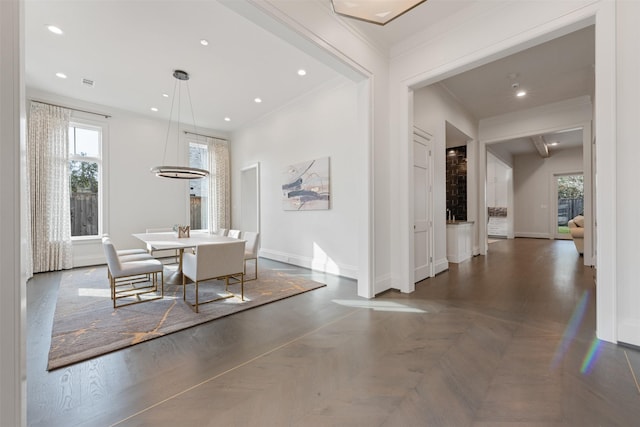 dining area with crown molding, plenty of natural light, and dark parquet floors