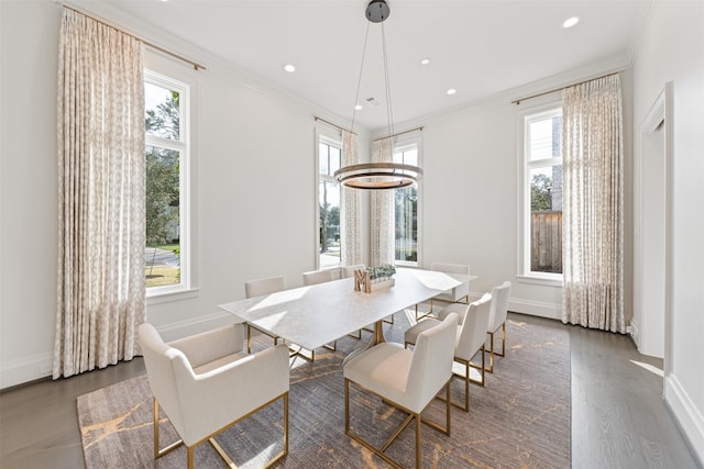 dining room featuring ornamental molding and dark hardwood / wood-style flooring