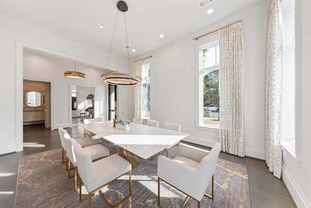 dining area with ornamental molding and dark hardwood / wood-style floors