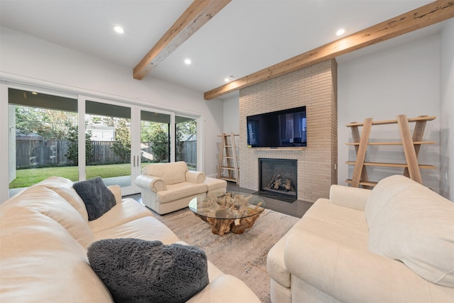 living room featuring a brick fireplace and beam ceiling