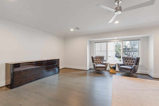 sitting room featuring hardwood / wood-style floors and ceiling fan