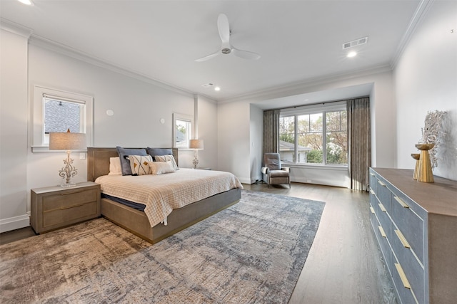 bedroom with hardwood / wood-style flooring, ceiling fan, ornamental molding, and multiple windows