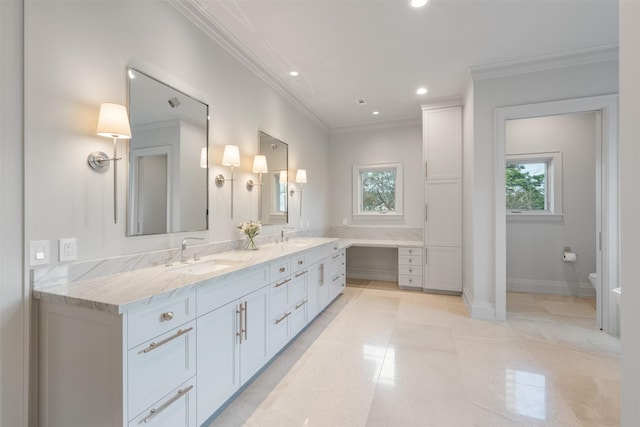 bathroom with crown molding, plenty of natural light, toilet, and vanity