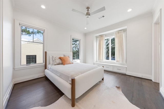 bedroom featuring crown molding, dark wood-type flooring, and ceiling fan