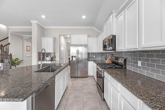 kitchen with sink, white cabinetry, a center island with sink, dark stone countertops, and stainless steel appliances