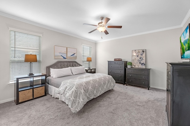 carpeted bedroom featuring crown molding and ceiling fan