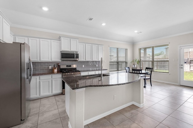 kitchen with sink, stainless steel appliances, an island with sink, and white cabinets