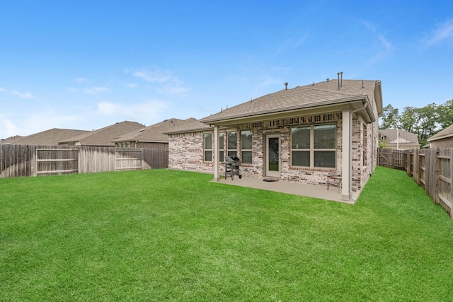 back of house with a yard and a patio area