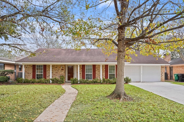 ranch-style house featuring a garage and a front lawn