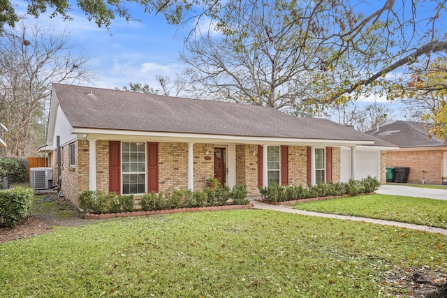 ranch-style home featuring a front lawn and central air condition unit