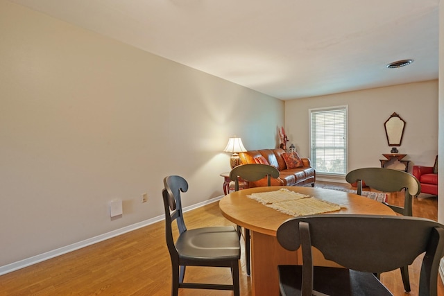 dining area with light hardwood / wood-style floors