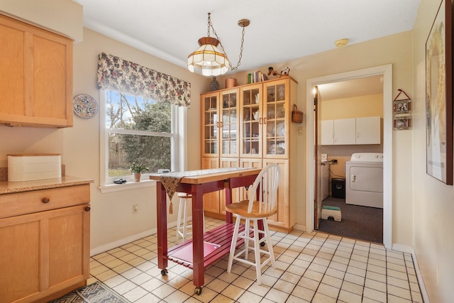 tiled dining area with washer / dryer