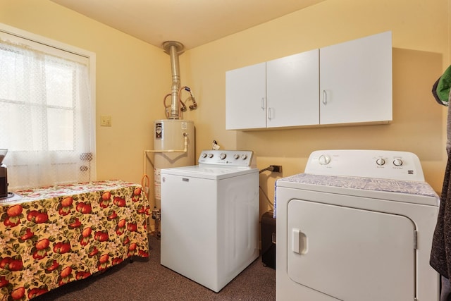 laundry area featuring cabinets, independent washer and dryer, dark carpet, and gas water heater