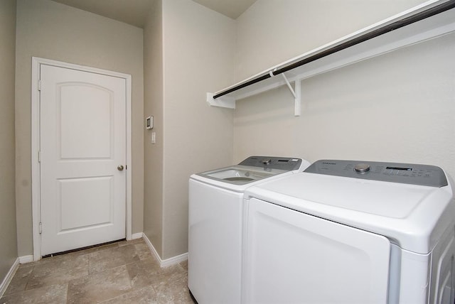 clothes washing area featuring separate washer and dryer