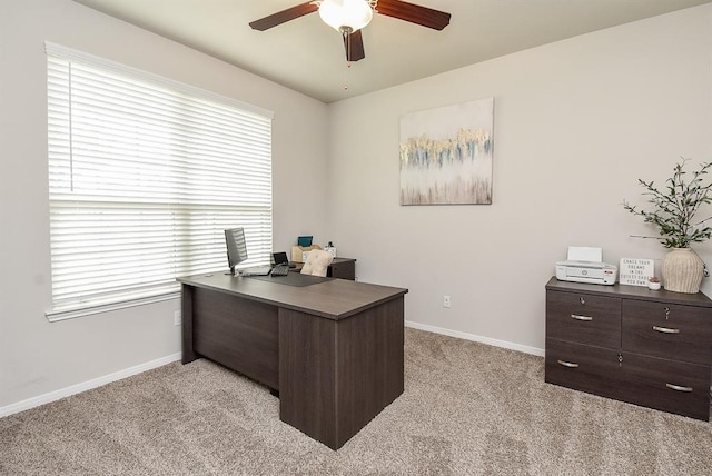 carpeted office space with ceiling fan