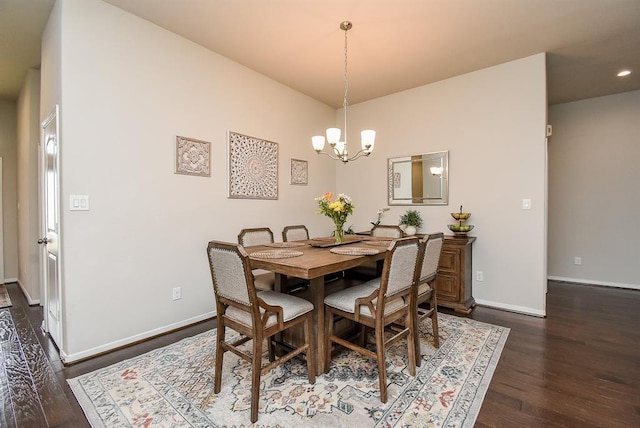 dining room featuring an inviting chandelier and dark hardwood / wood-style floors