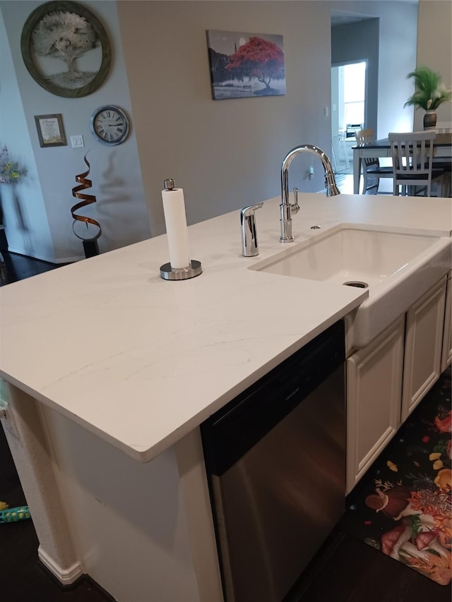 kitchen with white cabinetry, dishwasher, and sink