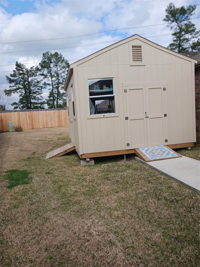 view of outbuilding featuring a lawn