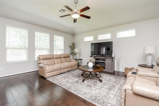 living room featuring dark hardwood / wood-style floors and ceiling fan