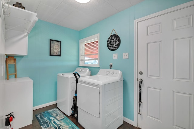 washroom with dark wood-type flooring and washer and clothes dryer