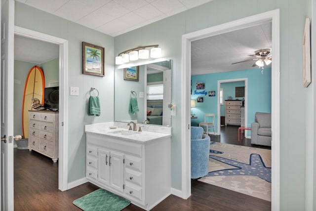 bathroom with hardwood / wood-style flooring, vanity, and ceiling fan