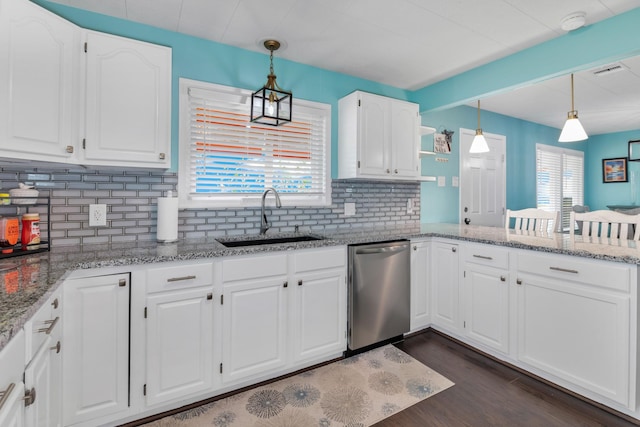 kitchen featuring white cabinetry, hanging light fixtures, sink, and dishwasher