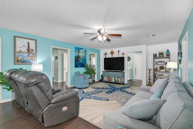 living room featuring ceiling fan and dark hardwood / wood-style flooring