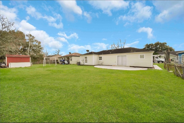 back of house with a patio area and a lawn