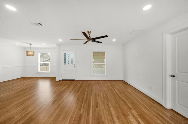 unfurnished living room featuring ornamental molding, light hardwood / wood-style floors, and ceiling fan