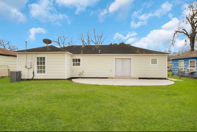 rear view of property with central AC, a patio, and a lawn